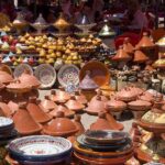 Des dizaines de poteries colorées et de vaisselle artisanale exposées en plein air
